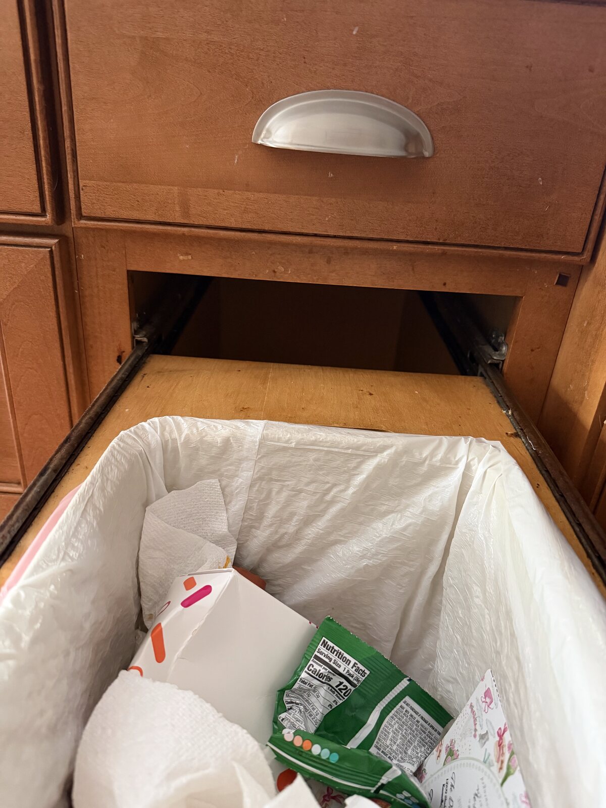 Custom wood housing built around a pull-out trash can, blocking the rim Trash Shield needs to clip onto